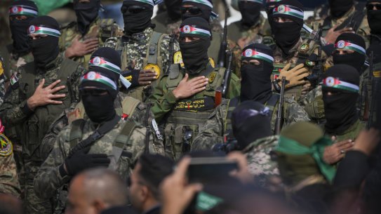 Hamas fighters prepare for the handover ceremony of Israeli hostages in Gaza on Saturday.