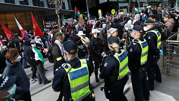 Protesters and police outside the Land Forces expo in Melbourne in September 2024.