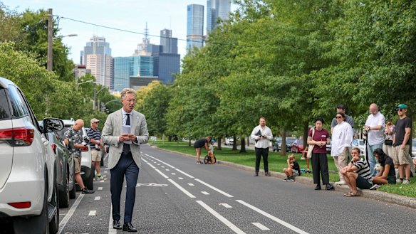 Auctioneer Charles Atkins looks to the crowd, as bids inch up in increments of $1000.