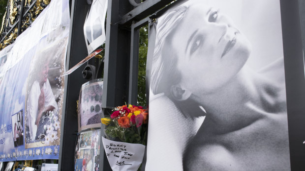 Flowers, tributes and images stand displayed on the gates of Kensington Palace in London, Tuesday, Aug. 31, 2021, to mark the 24th anniversary of the death of Princess Diana. Diana’s life was cut short in a 1997 car crash in Paris, but her legend lives on and the woman then-Prime Minister Tony Blair dubbed “the People’s Princess” still retains a loyal following. (AP Photo/Urooba Jamal)