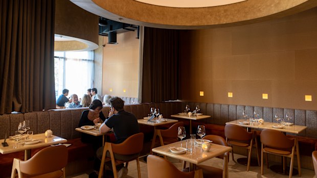 Moya & Co studio has designed an elegant dining room with a stunning cylindrical ceiling feature.