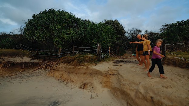Byron locals Julia Spicer with partner James Harvey and son Kitt, 9, check out the erosion at Tallow Beach Suffolk Park.