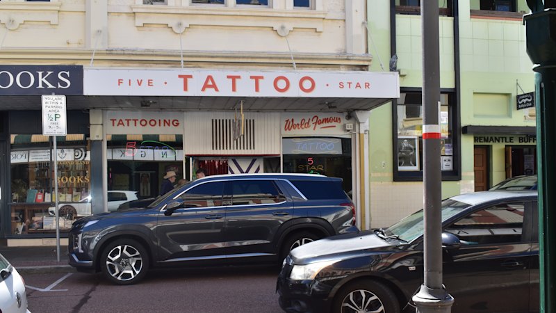 Local tattoo shop bracing for long night as Dockers fans chase inaugural premiership ink