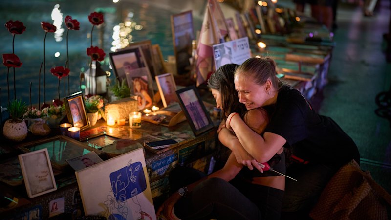 Israel pauses to mark October 7, with a soundtrack of war from Gaza