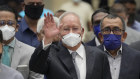 Former Malaysian Prime Minister Najib Razak, centre, wearing a face mask, arrives at the Court of Appeal in Putrajaya, Malaysia.