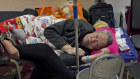 An elderly man takes a rest in a corridor in an emergency ward in Beijing.