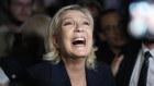 Marine Le Pen reacts as she meets supporters and journalists after the release of projections based on the actual vote count in select constituencies.