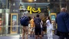 Customers line up outside an Optus shop front on George Street in Sydney during a country-wide network outage.