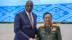 Laotian Defence Minister Chansamone Chanyalath welcomes US Defence Secretary Lloyd Austin in Vientiane on Thursday.