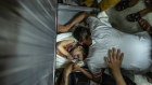 Palestinians inspect bodies of  children who were killed in an Israeli airstrike at the weekend. 