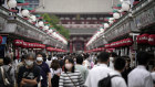 Japan’s economy is too weak for the central bank to wind back bond buying, officials say.