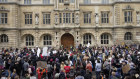 Protesters gather outside Oxford University's Oriel College, demanding the removal of a Cecil Rhodes statue from its facade.