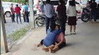 In this image taken from video, a distraught woman is comforted outside the site of an attack.