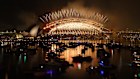 Golden fireworks spray from the Sydney Harbour Bridge.