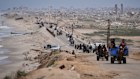 Displaced Palestinians move between southern and northern Gaza on the outskirts of Gaza City.