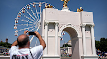 Visitors take photos of a model of President Donald Trump’s proposed Triumphal Arch.