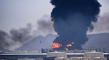 As bad as it seems? No, it’s worse, say a select group of voices. Smoke rises after debris from an intercepted Iranian drone struck an oil facility in Fujairah, UAE, in March.