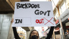 A protester holds a placard during a demonstration demanding that Prime Minister Muhyiddin Yassin step down.
