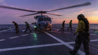 A Seahawk helicopter prepares to take off from the deck of HMAS Hobart.