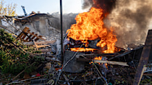 A car burns following a Russian strike on a residential neighbourhood in Kharkiv, Ukraine, on Sunday, October 11,
