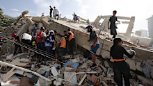 Search crews look for survivors and bodies underneath the rubble in Venezuela. 