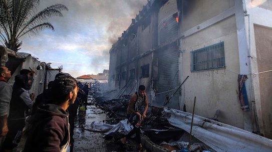 Palestinians try to extinguish a fire at a building of an UNRWA vocational training centre earlier this week.