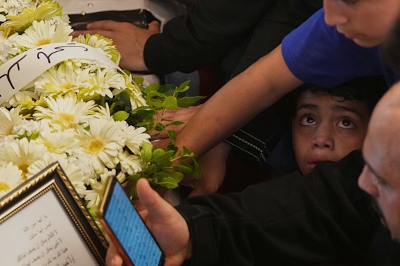 A boy reacts as mourners gather around the coffins of Palestinian fighters Hozeifa Hamza Ghannamieh and Ibrahim Anwar al-Khalayli, who were killed while fighting alongside Hezbollah against Israel in southern Lebanon, during their funeral in Beirut, Lebanon.