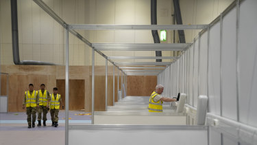 The UK military and contractors build an initial 500 beds at the NHS Nightingale Hospital at London's ExCel Centre.