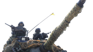 Two soldiers guard on a tank during a military exercise in Hsinchu County, northern Taiwan.
