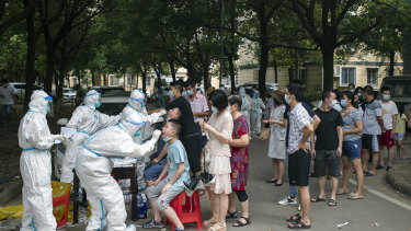 Residents line up to be tested for COVID-19 in Wuhan.