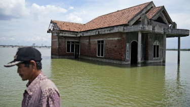 A house inundated by water due to the rising sea level in Sidogemah, Central Java, on November 8.