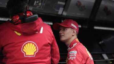Schumacher talks to a Ferrari team member during his first F1 test.