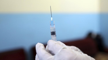 A doctor fills a syringe with the Sinopharm COVID-19 vaccine at a vaccination centre in Kabul. 