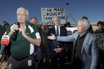 Nationals MP Damian Drum and then-Deputy Prime Minister Michael McCormack address farmers angry over the Murray-Darling Basin Plan in December 2019, with One Nation’s Malcolm Roberts (right) waiting to pounce.