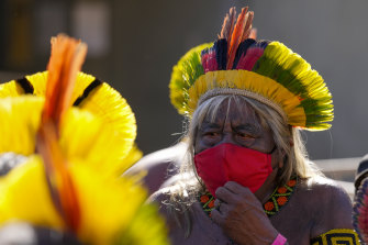 Xavante Indigenous leader Megaron stands outside Congress during a protest in Brasilia, Brazil. President Jair Bolsonaro says his “Indigenous brothers” want to be integrated into white society.