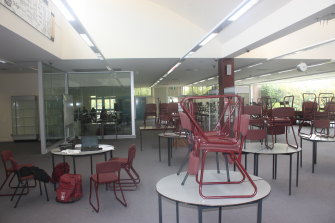 The school's library was so rarely used chairs stayed stacked on tables all day.
