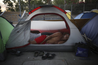 A Cuban migrant sleeps inside a tent at the foot of the bridge linking Brownsville in Texas to Matamoros in Mexico.