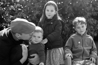 In this 2019 family photo by Catherine, Prince William kisses Prince Louis as they pose next to Princess Charlotte and Prince George in Norfolk. 