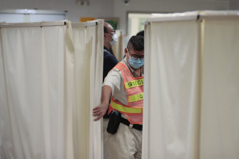 A security guard closes the curtain at the ICU ward where university student Alex Chow was being treated.