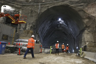 Workers walk through a tunnel to the station's giant cavern about 30 metres below the surface.