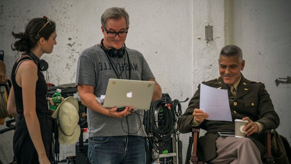 Luke Davies, centre, and George Clooney, right, enjoy a lighter moment in a script reading on Catch-22.