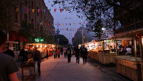 Anti-riot police patrol Kashgar's night markets armed with batons. 