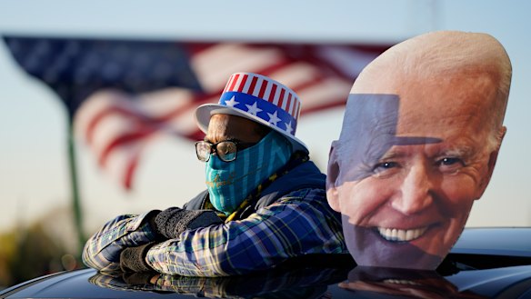 A Democrat supporter watches Joe Biden address a rally in Michigan on Saturday.