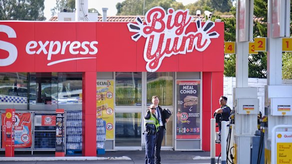 Police are seen at the Coles Express petrol station at the corner of Kings Road and Melton Highway. 