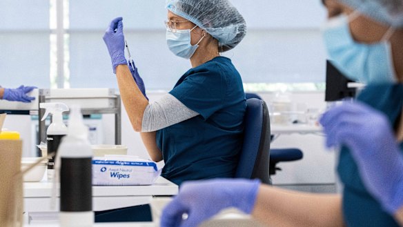 Pharmacists prepare the Pfizer vaccine at the Sydney Olympic Park mass vaccination clinic.