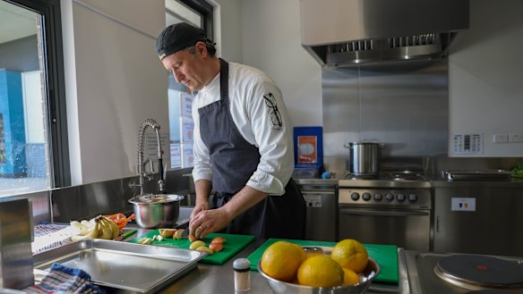 Simone Biancalani prepares food for about 100 students at Melton Specialist School but the kitchen is not big enough to expand the successful program. 