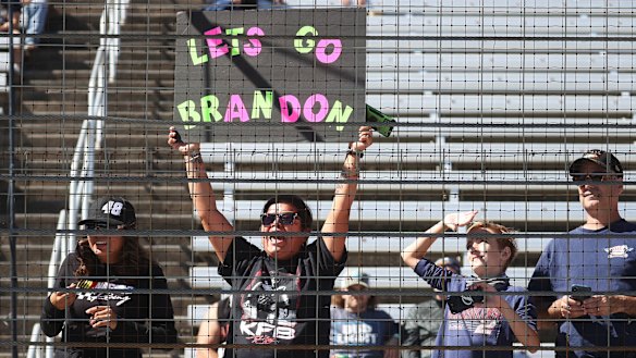 A NASCAR fan holds a “Lets Go Brandon” sign at a race in Fort Worth, Texas.