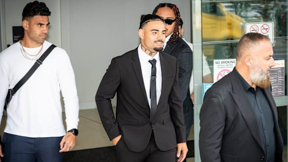 Taylan May (centre) leaves Penrith Local Court flanked by his brother Terrell (left).