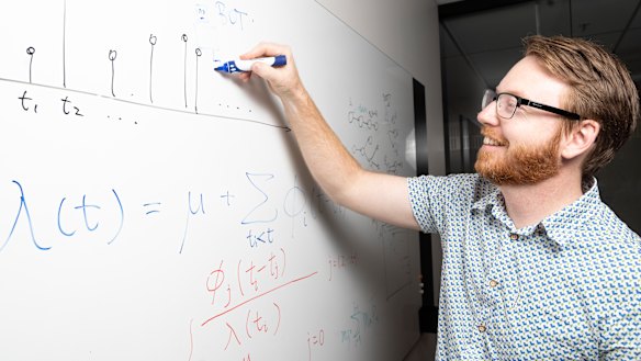 Dr Timothy Graham of the Research School of Social Sciences next to the algorithm which has helped track the influence of bots in the 2016 US election