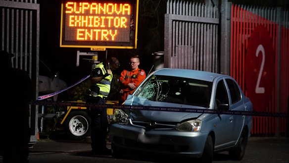 Emergency services examine the car that mounted the kerb and struck two pedestrians.
